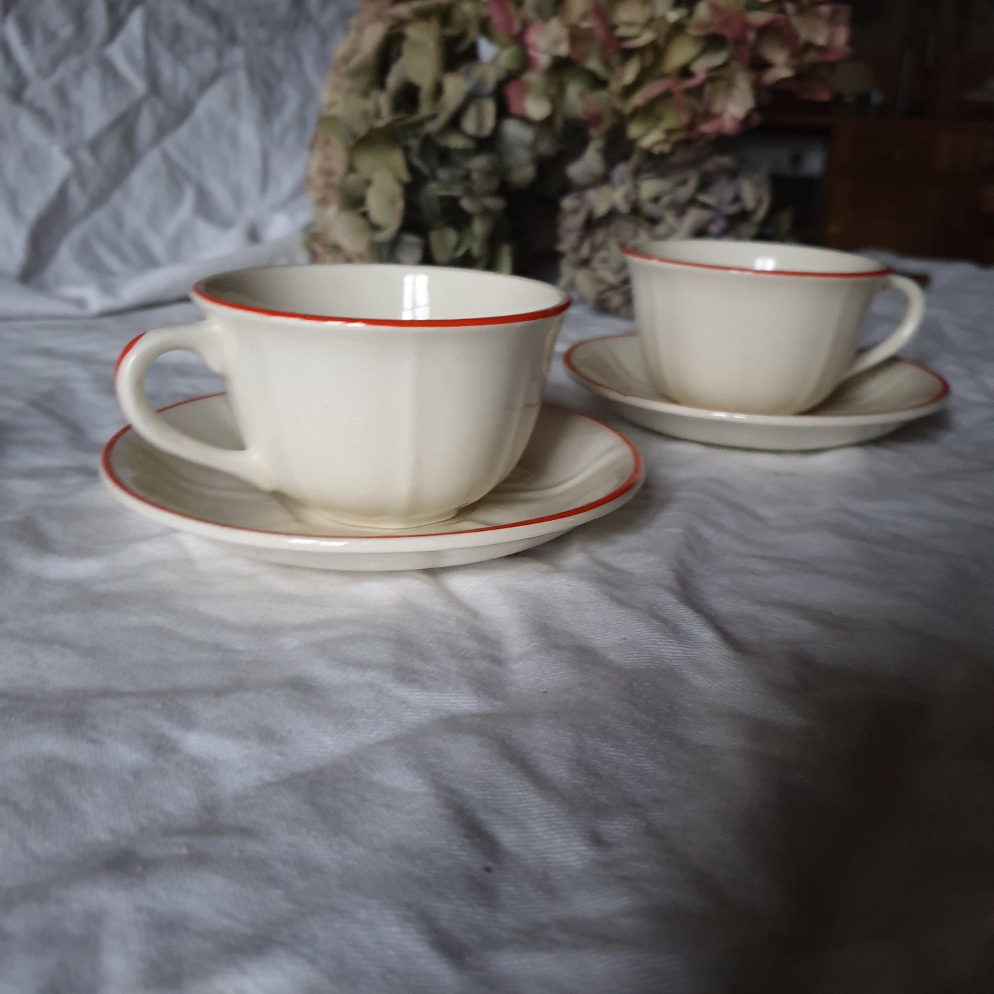 PAIR K&G Luneville French cups w saucers, early Art Deco, c1910-20 red and white w subtle pearlescent finish, hand painted French faience