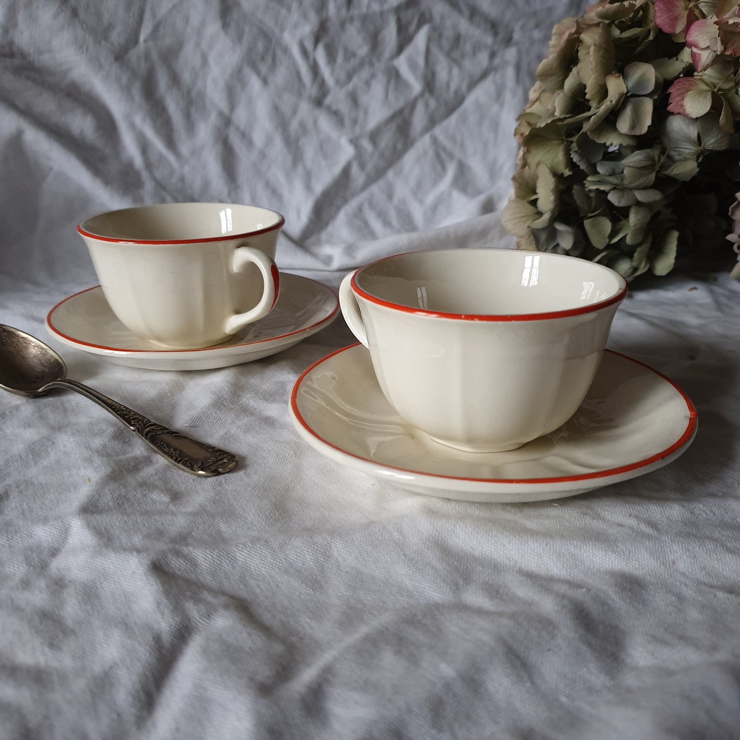 PAIR K&G Luneville French cups w saucers, early Art Deco, c1910-20 red and white w subtle pearlescent finish, hand painted French faience
