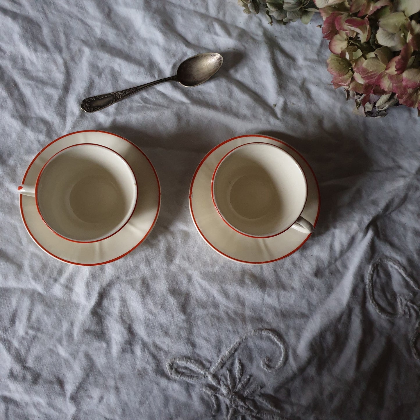 PAIR K&G Luneville French cups w saucers, early Art Deco, c1910-20 red and white w subtle pearlescent finish, hand painted French faience
