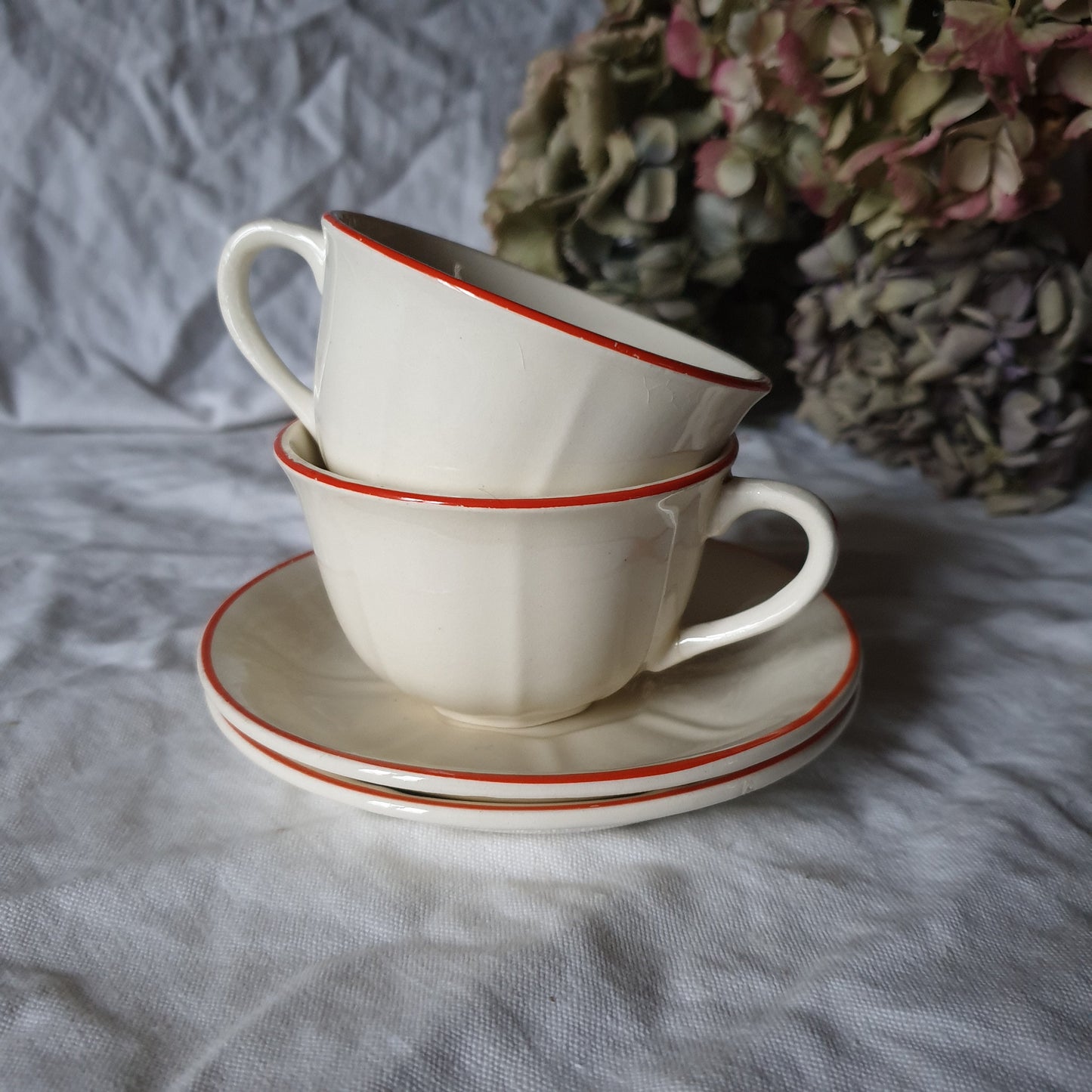 PAIR K&G Luneville French cups w saucers, early Art Deco, c1910-20 red and white w subtle pearlescent finish, hand painted French faience