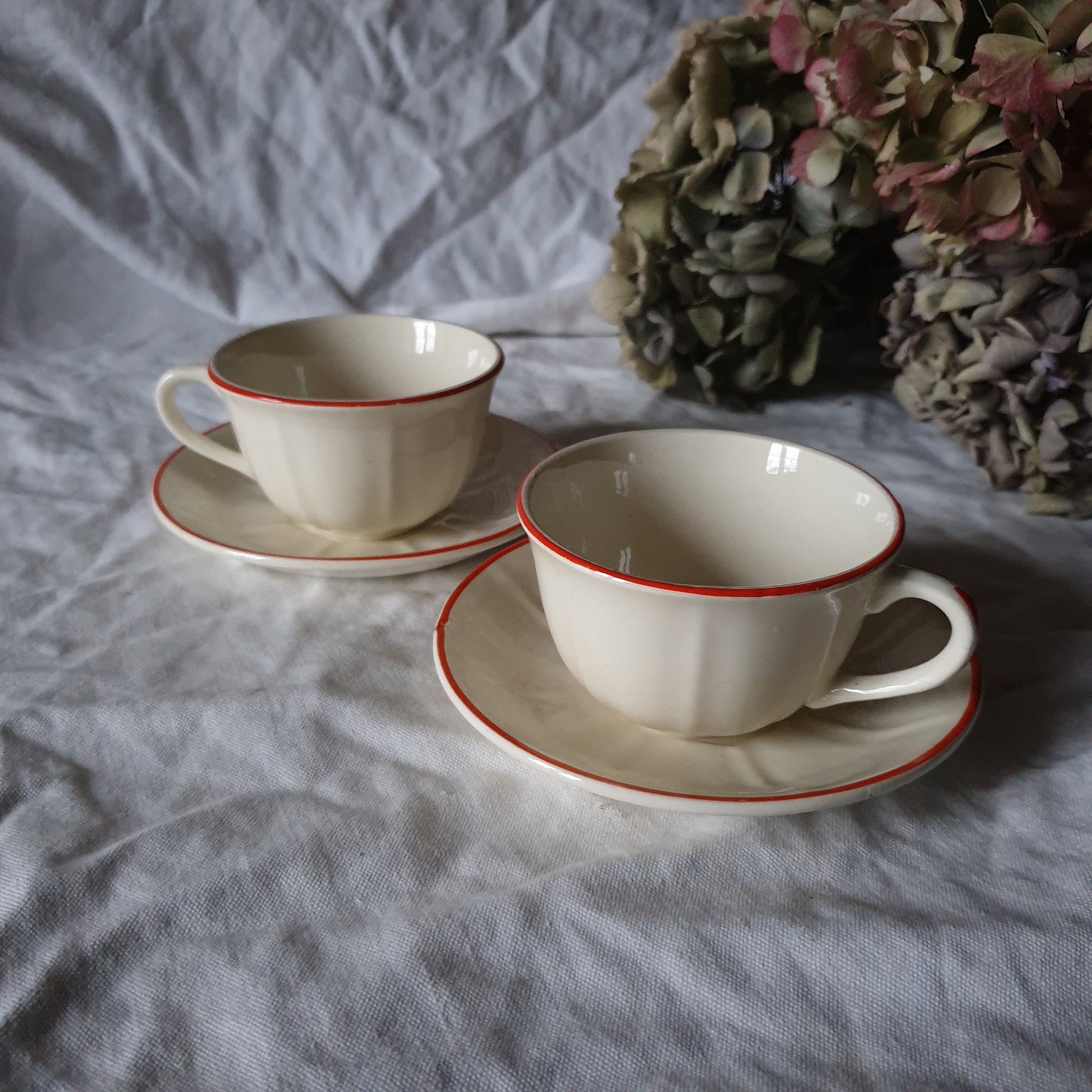 PAIR K&G Luneville French cups w saucers, early Art Deco, c1910-20 red and white w subtle pearlescent finish, hand painted French faience