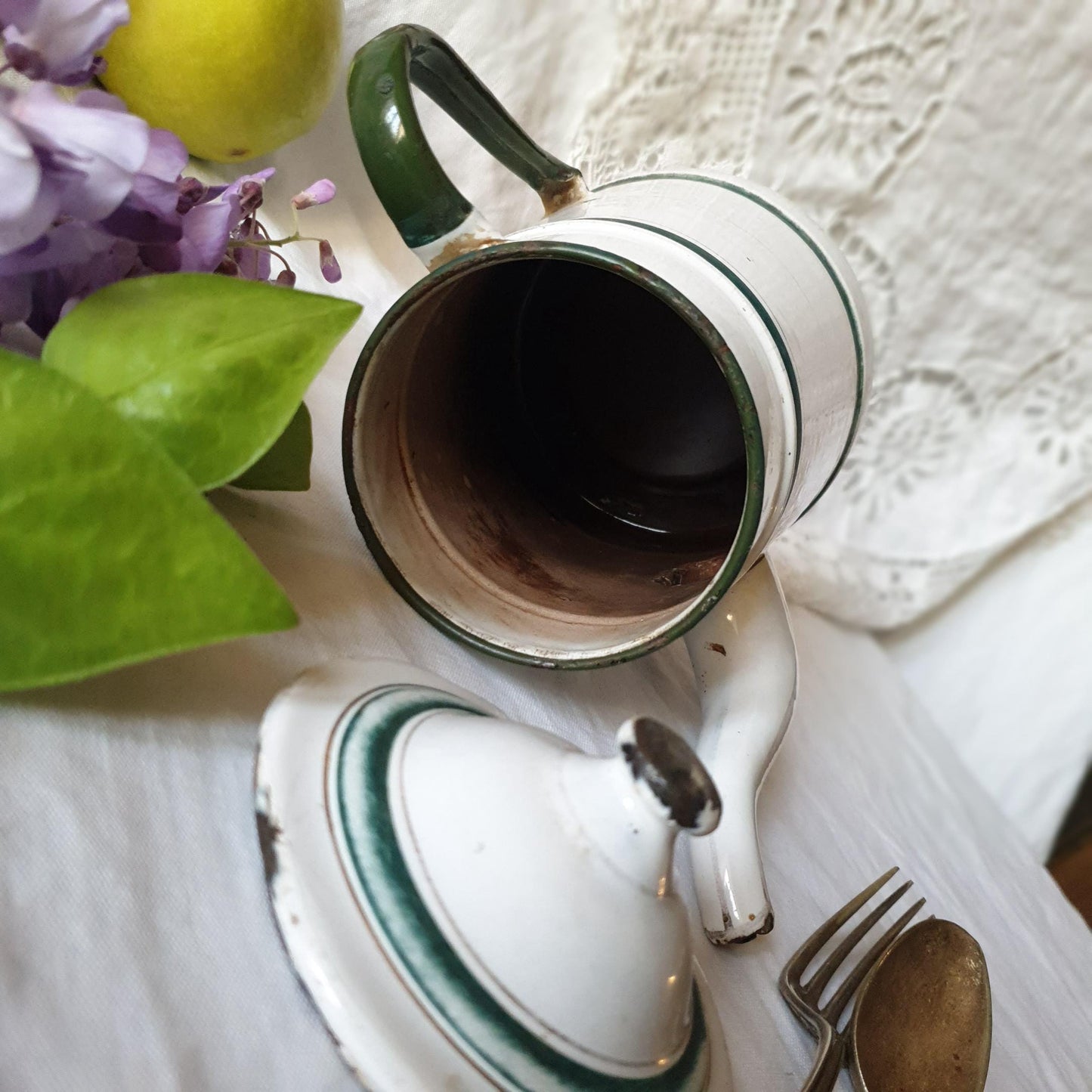 Interior view of French vintage enamel coffee pot with chippy paint