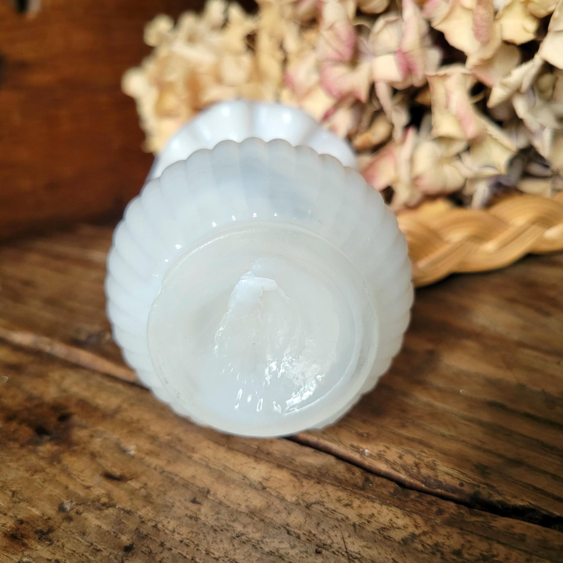 Base of a small French vase in white opaline milk glass, showing pontil mark, a sign of hand made blowing process