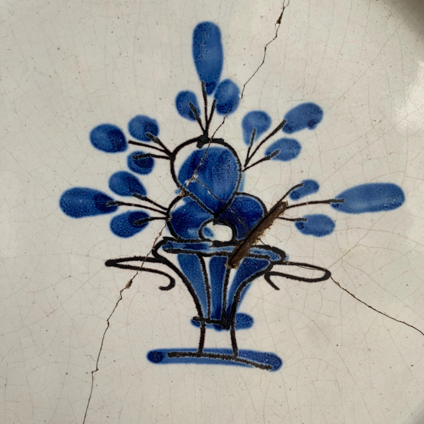 Antique round cul noir platter basket of flowers design with staple repairs. Rouen France c1880