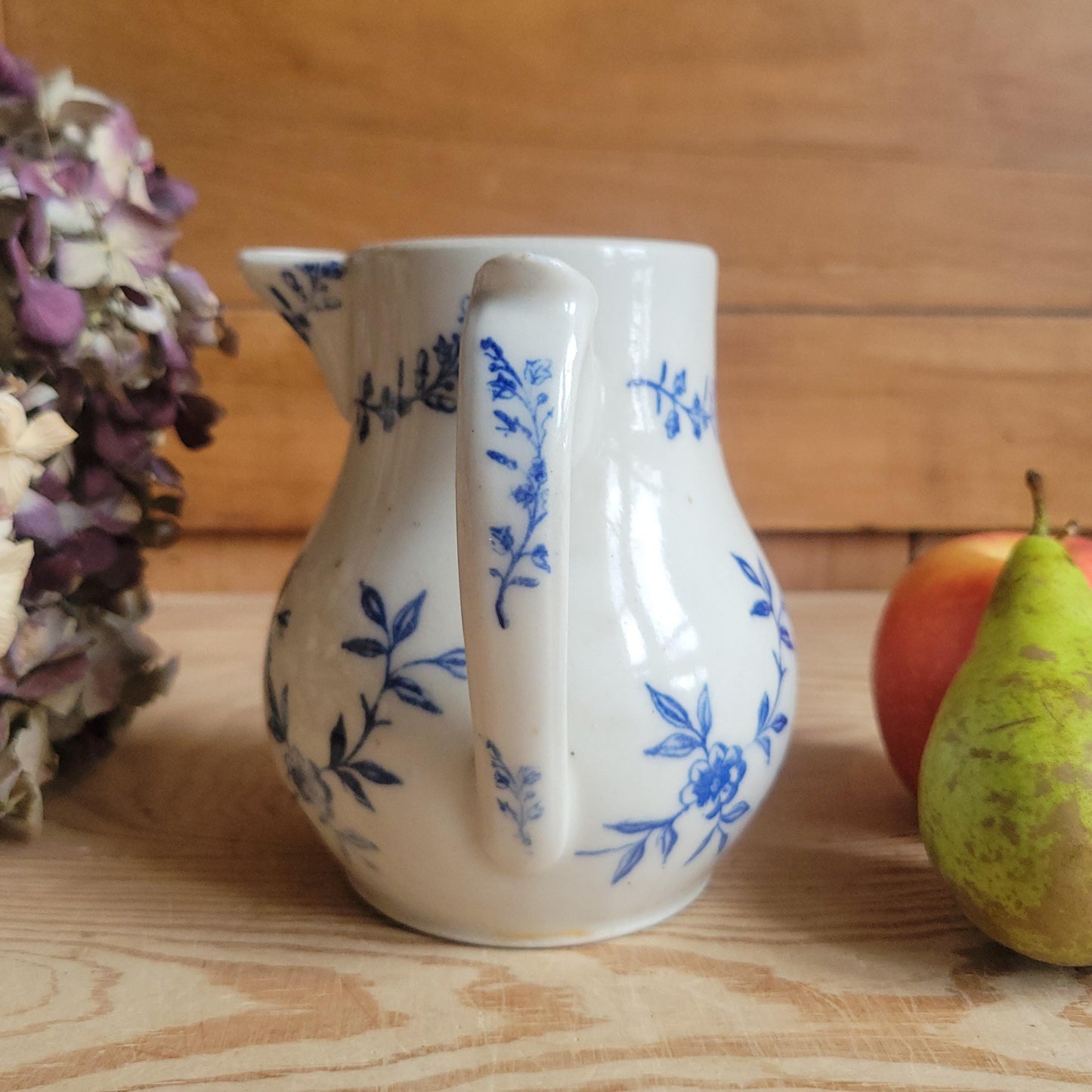 Antique stoneware milk jug with offset handle blue and white florals and leaves St Uze France c 1900