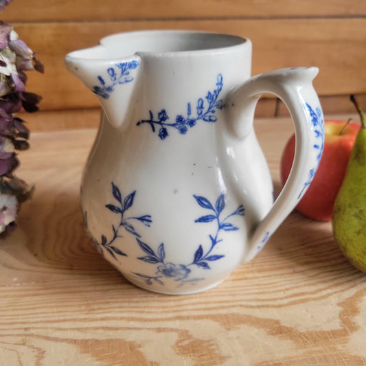 Antique stoneware milk jug with offset handle blue and white florals and leaves St Uze France c 1900