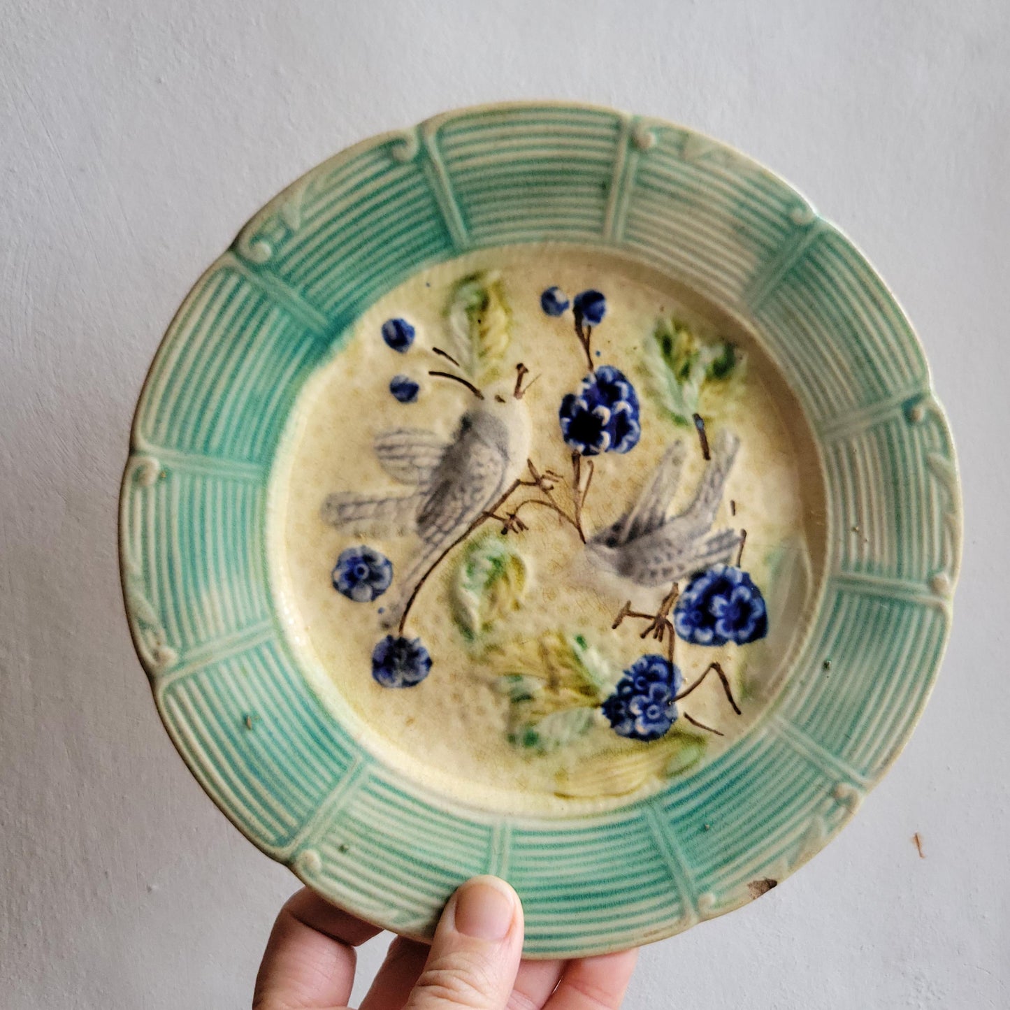 French antique barbotine majolica plate, songbirds on flower branch design, polychrome on cream-yellow ground, ridged border, France c1890