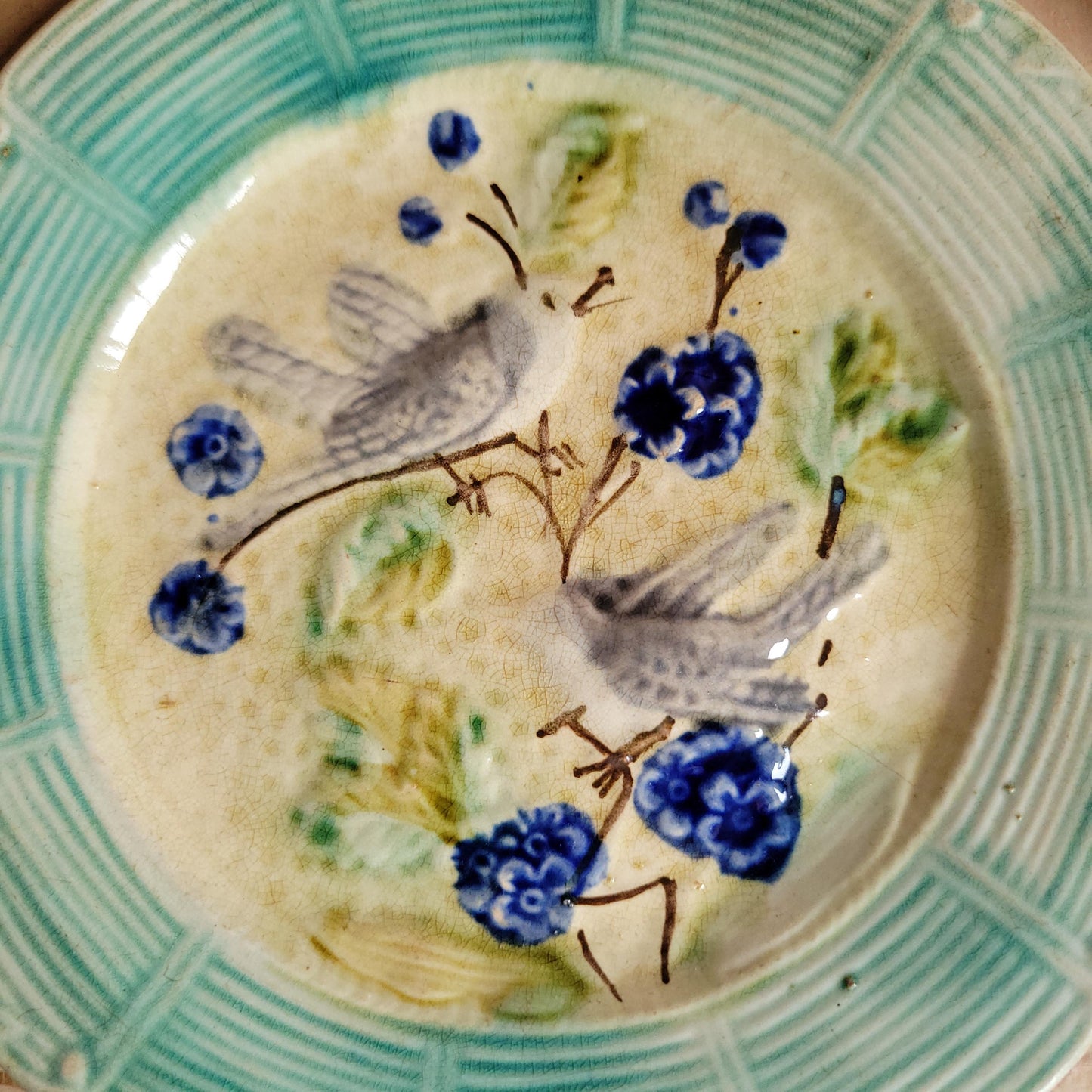 French antique barbotine majolica plate, songbirds on flower branch design, polychrome on cream-yellow ground, ridged border, France c1890