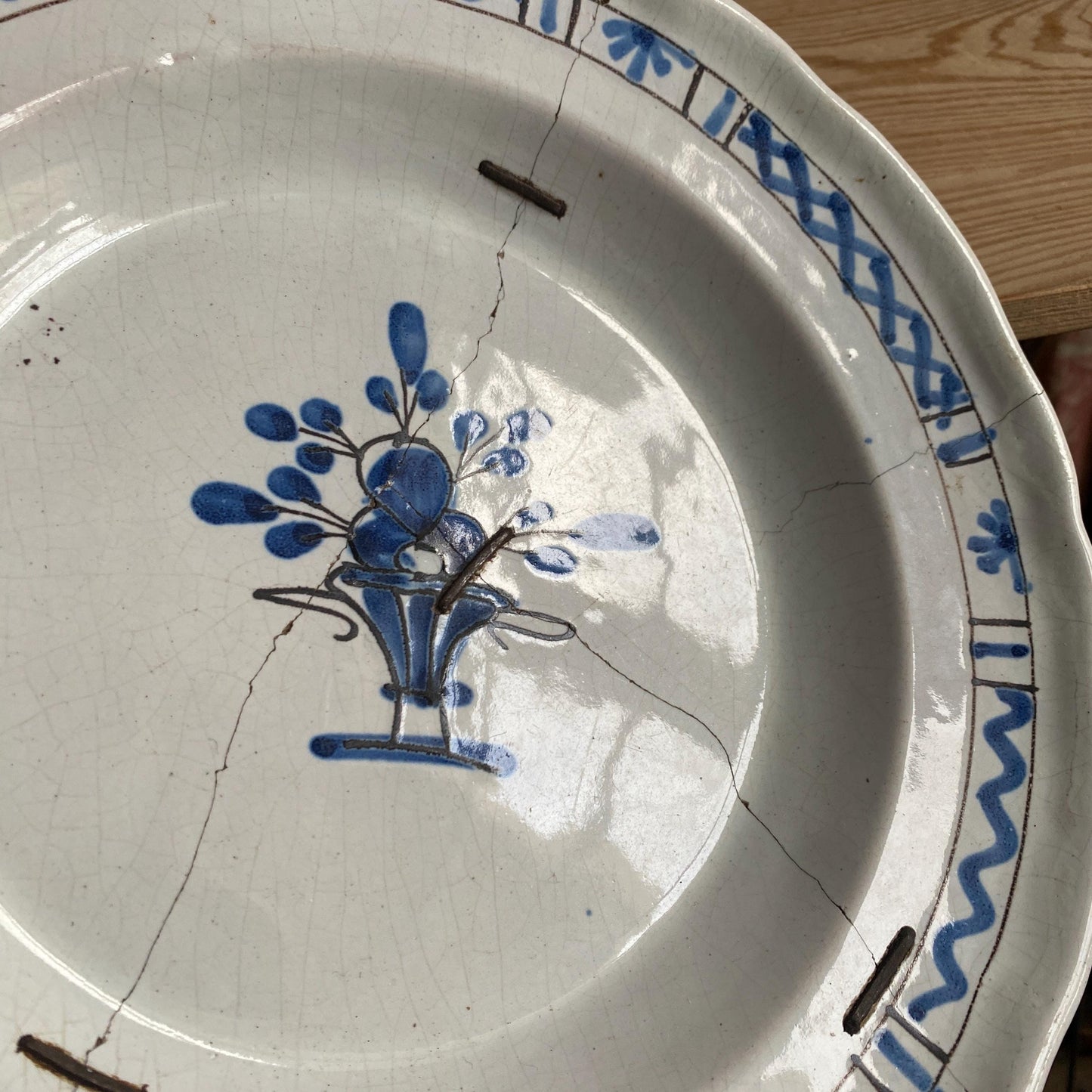 Antique round cul noir platter basket of flowers design with staple repairs. Rouen France c1880