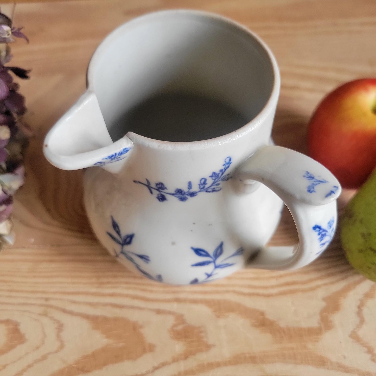 Antique stoneware milk jug with offset handle blue and white florals and leaves St Uze France c 1900
